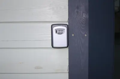 a cell phone is hanging on a wooden wall at Old Slabada Apartments in Kaunas