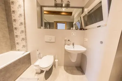 a bathroom with a sink and a toilet and a bath tub at Apartments Ameda in Vilnius