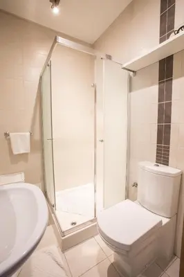 a bathroom with a shower and a toilet and a sink at Apartments Ameda in Vilnius