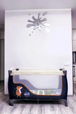 a bed in a room with a snowflake on the wall at Butas miesto centre in Panevėžys