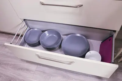 a drawer with four plates and bowls in it at Butas miesto centre in Panevėžys