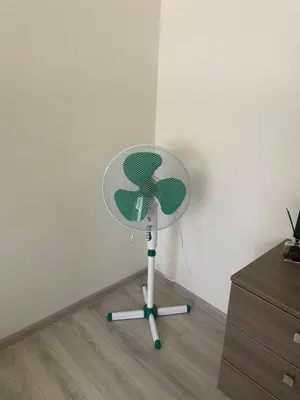 a fan sitting in the corner of a room at Butas miesto centre in Panevėžys