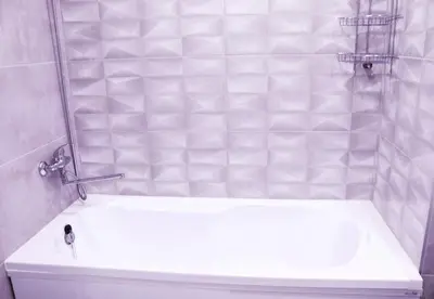 a bathroom with a white tub and a sink at Butas miesto centre in Panevėžys