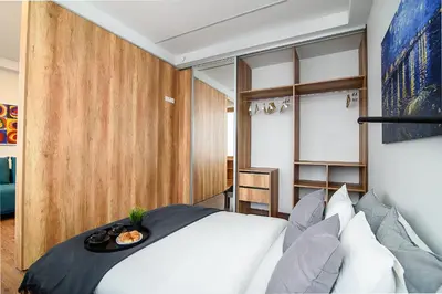 a bedroom with a white bed with a tray on it at Apartment with amazing view! in Vilnius
