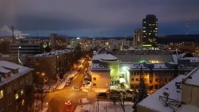 a city at night with snow on the roofs at Apartment with amazing view! in Vilnius