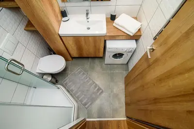 an overhead view of a bathroom with a sink and a shower at Apartment with amazing view! in Vilnius
