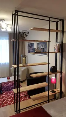 a bedroom with a loft bed with a living room at Girelės apartamentai in Kaišiadorys