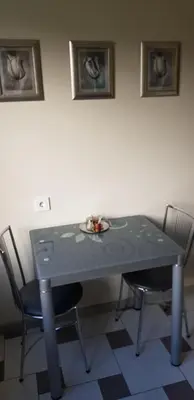 a table with two chairs and a plate on it at Girelės apartamentai in Kaišiadorys