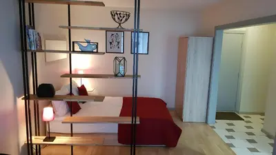 a bedroom with a bed and a book shelf at Girelės apartamentai in Kaišiadorys