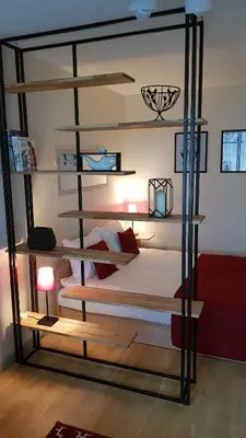 a bedroom with a bunk bed with a black frame at Girelės apartamentai in Kaišiadorys