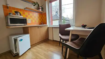a small kitchen with a table and a microwave at Nileja in Vilnius