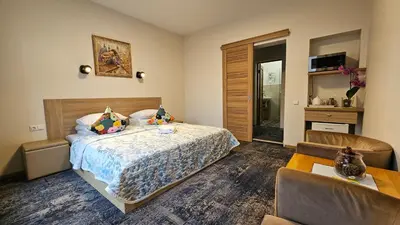 a bedroom with a bed and a table and chairs at Nileja in Vilnius