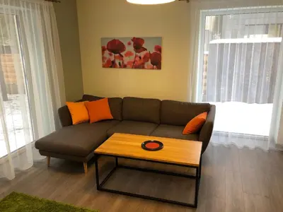 a living room with a couch and a coffee table at Poilsio apartamentai 