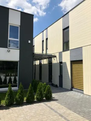 a black and white building with a garage at Poilsio apartamentai 