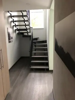 a spiral staircase in a room with a window at Poilsio apartamentai 