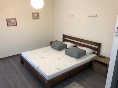 a bedroom with a bed with two pillows on it at Poilsio apartamentai 