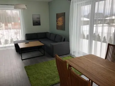 a living room with a couch and a table at Poilsio apartamentai 