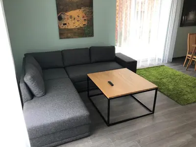 a living room with a couch and a coffee table at Poilsio apartamentai 