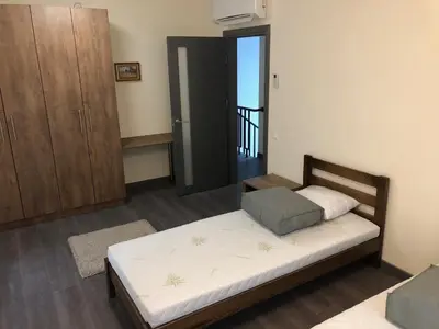 a bedroom with a bed and a door to a balcony at Poilsio apartamentai 