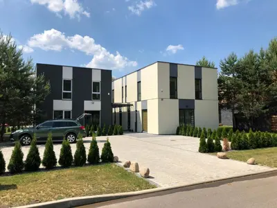a building with a car parked in front of it at Poilsio apartamentai 