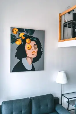 a painting of a woman with oranges on her head at Brother House Kaunas in Kaunas