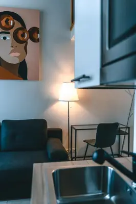 a living room with a couch and a painting of a woman at Brother House Kaunas in Kaunas