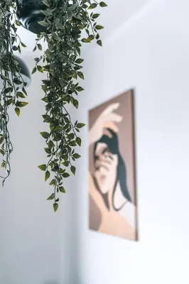 a picture of a woman on a wall with ivy at Brother House Kaunas in Kaunas