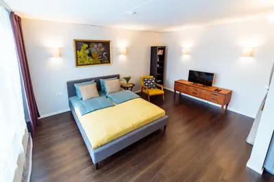 a bedroom with a bed and a television in it at Romantic apartment close to the Old Town in Vilnius