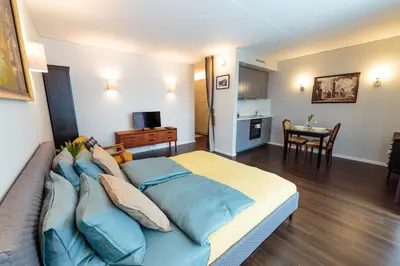 a bedroom with a large bed with blue pillows at Romantic apartment close to the Old Town in Vilnius