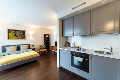 a kitchen with a sink and a bed in a room at Romantic apartment close to the Old Town in Vilnius