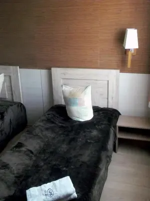 a hotel room with a bed with a pillow on it at Kambarių nuoma - Rumšiškės SAURIDA in Rumšiškės