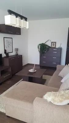 a living room with a couch and a table at Gardino Apartamentai in Šiauliai