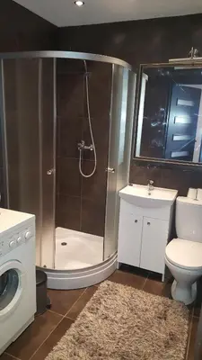 a bathroom with a shower and a toilet and a sink at Gardino Apartamentai in Šiauliai