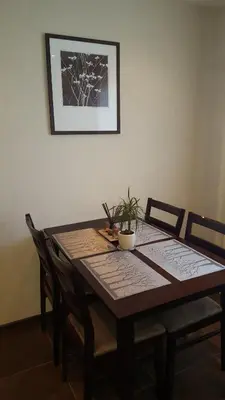 a dining room table with a plant on top of it at Gardino Apartamentai in Šiauliai