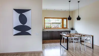 a kitchen and dining room with a table and chairs at Aušra in Druskininkai