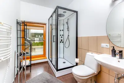 a bathroom with a shower and a toilet and a sink at Aušra in Druskininkai