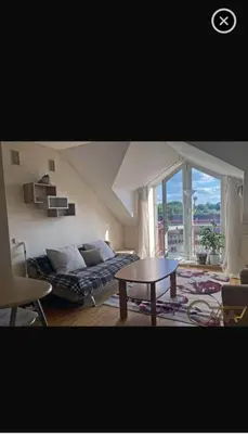 a living room with a couch and a table at Velux in Vilnius