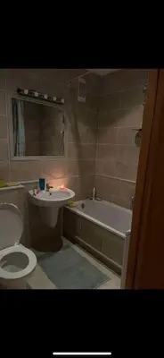 a bathroom with a toilet and a sink and a tub at Velux in Vilnius