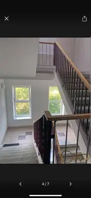a staircase in a house with two windows at Velux in Vilnius