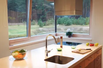 a kitchen counter with a sink and a window at Ami Residence in Druskininkai