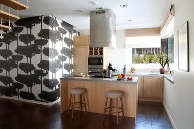 a kitchen with a black and white patterned wall at Ami Residence in Druskininkai