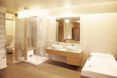 a bathroom with two sinks and a large mirror at Ami Residence in Druskininkai