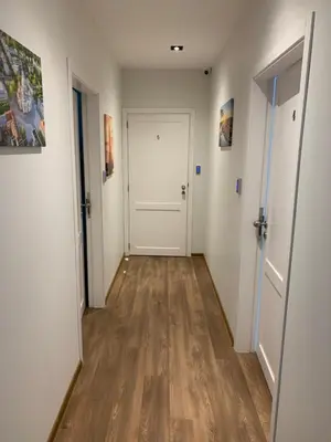 an empty hallway with white walls and wood floors at Oak house apartments in Kaunas