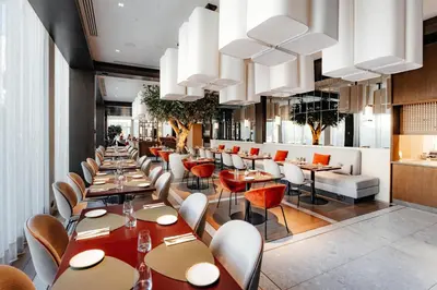 a dining room with tables and chairs at Hilton Garden Inn Vilnius City Centre in Vilnius