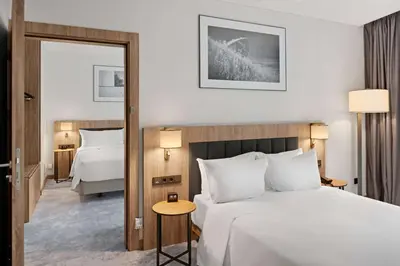a hotel room with a large bed and a mirror at Hilton Garden Inn Vilnius City Centre in Vilnius