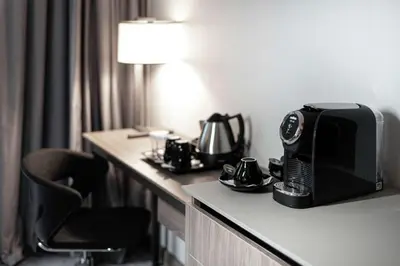 a hotel room with a microwave sitting on a table at Hilton Garden Inn Vilnius City Centre in Vilnius