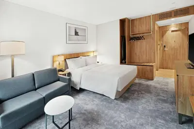 a hotel room with a bed and a couch at Hilton Garden Inn Vilnius City Centre in Vilnius
