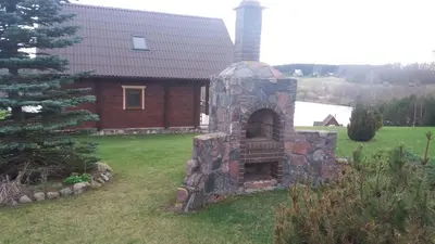 a stone oven in the yard of a house at Country Houses Vidų Sodyba in Utena