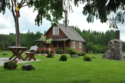 a house with a picnic table in front of it at Country Houses Vidų Sodyba in Utena