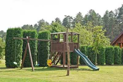 a wooden playground with a slide at Sodyba Latkrantė, Druskininkai in Latežeris